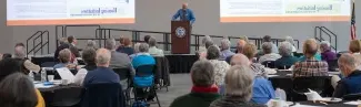 Tom Meuser speaks to an audience at a Legacy Scholars Breakfast for the Center of Excellence in Aging and Health